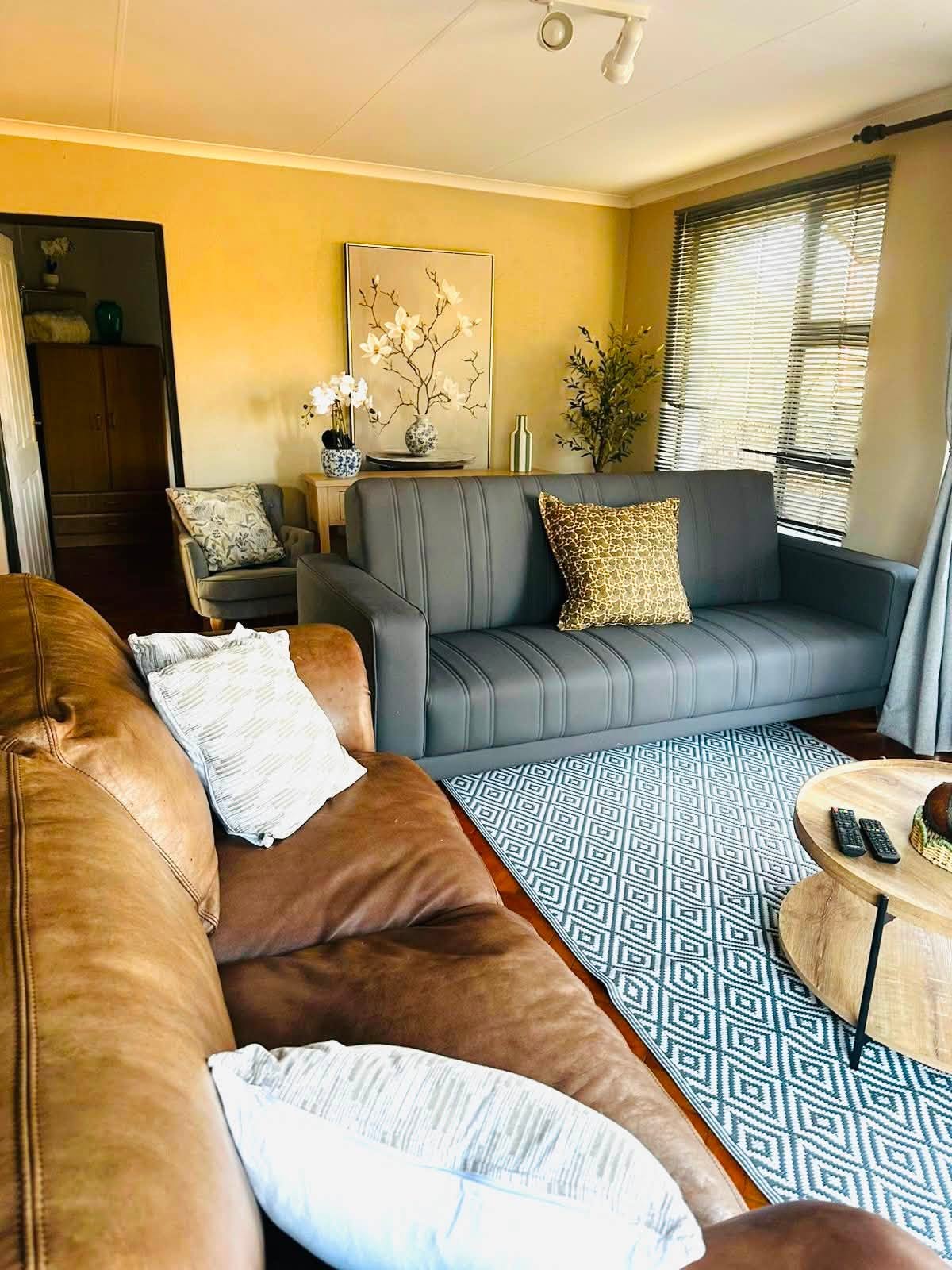 Elegant living area with soft seating and natural light in the Wild Olive Suite